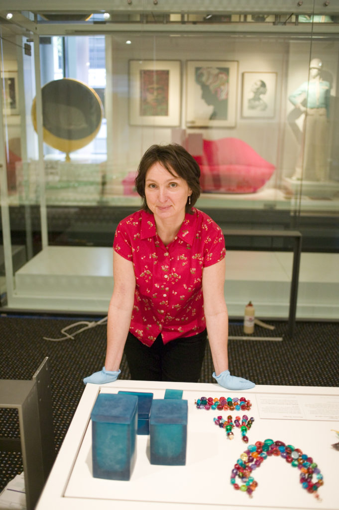 Curator Eva Czernis-Ryl installing ‘Dinosaur Designs’ jewellery